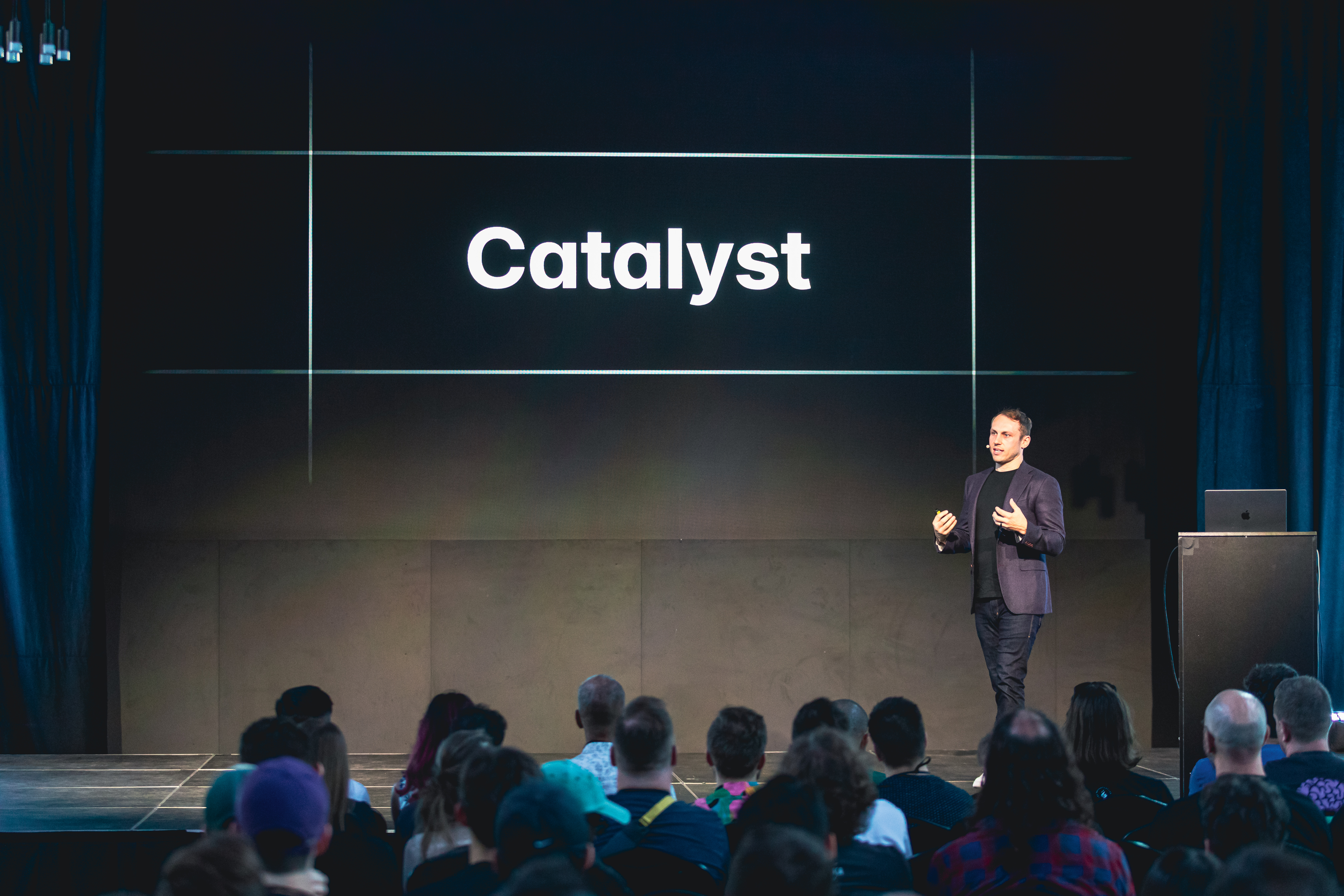 Adam Wathan on stage in front of a slide that says Catalyst